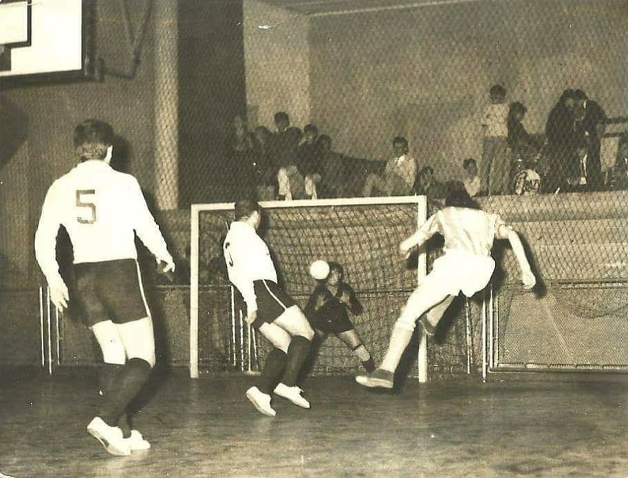 Players gathered on an early indoor futsal court in Brazil